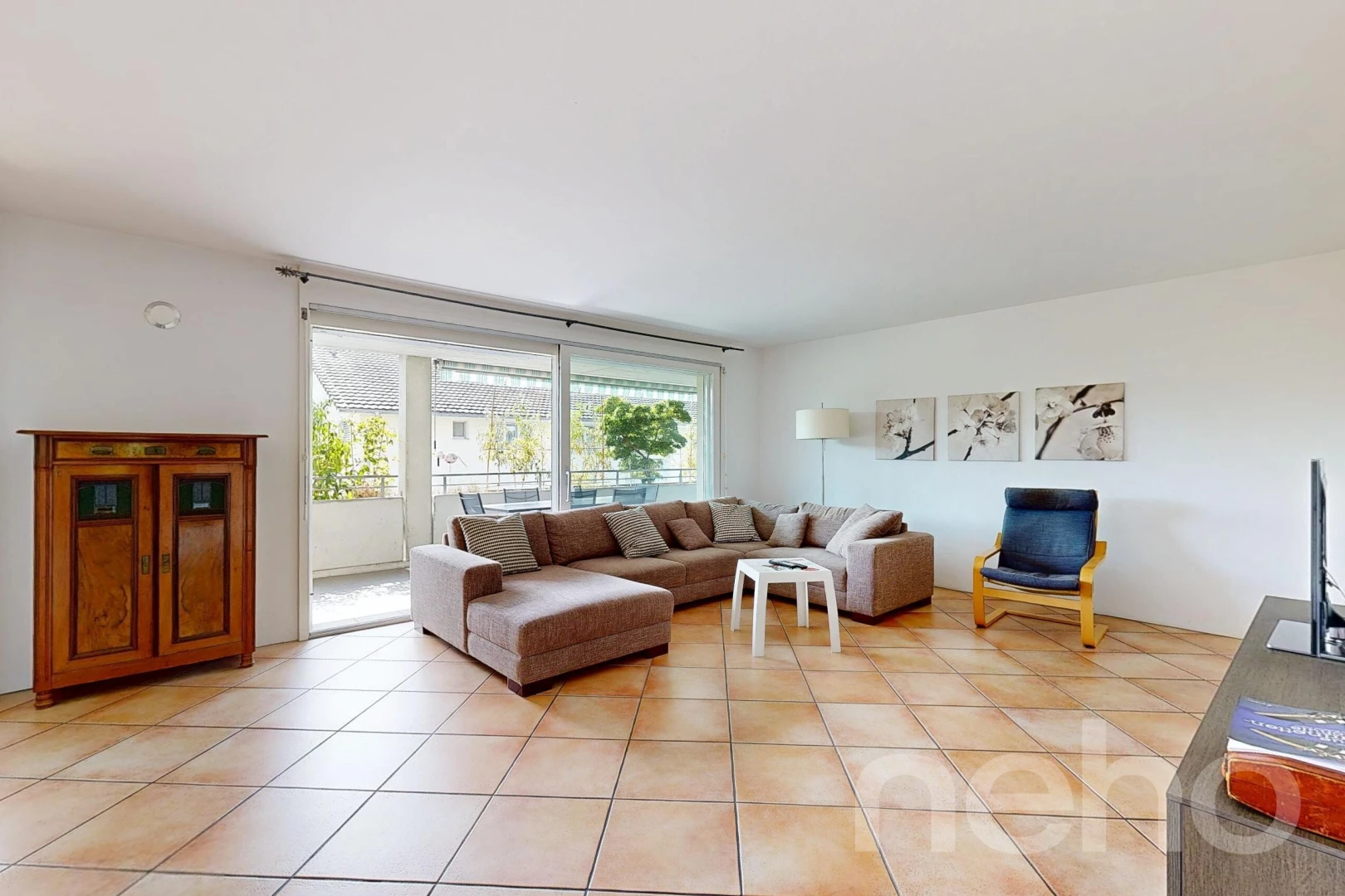 living area featuring light tile patterned flooring and access to outside