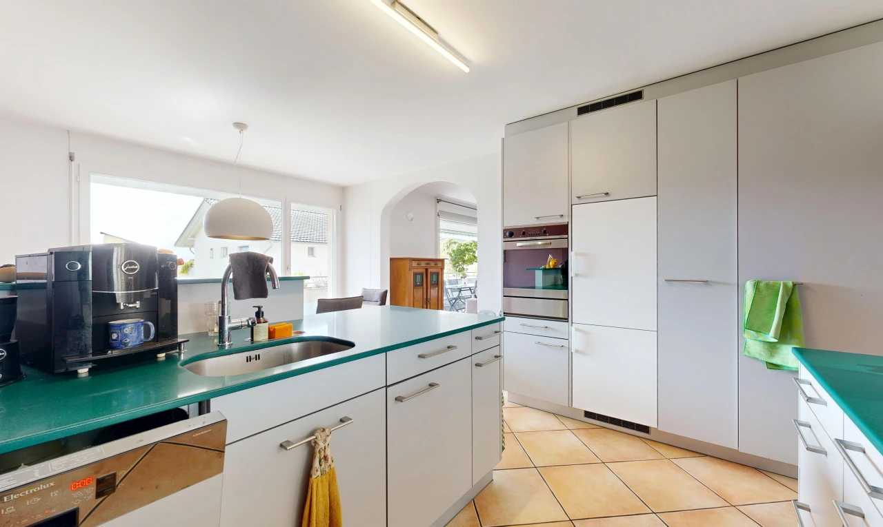 kitchen with arched walkways, pendant lighting, dishwashing machine, light tile patterned flooring, and oven
