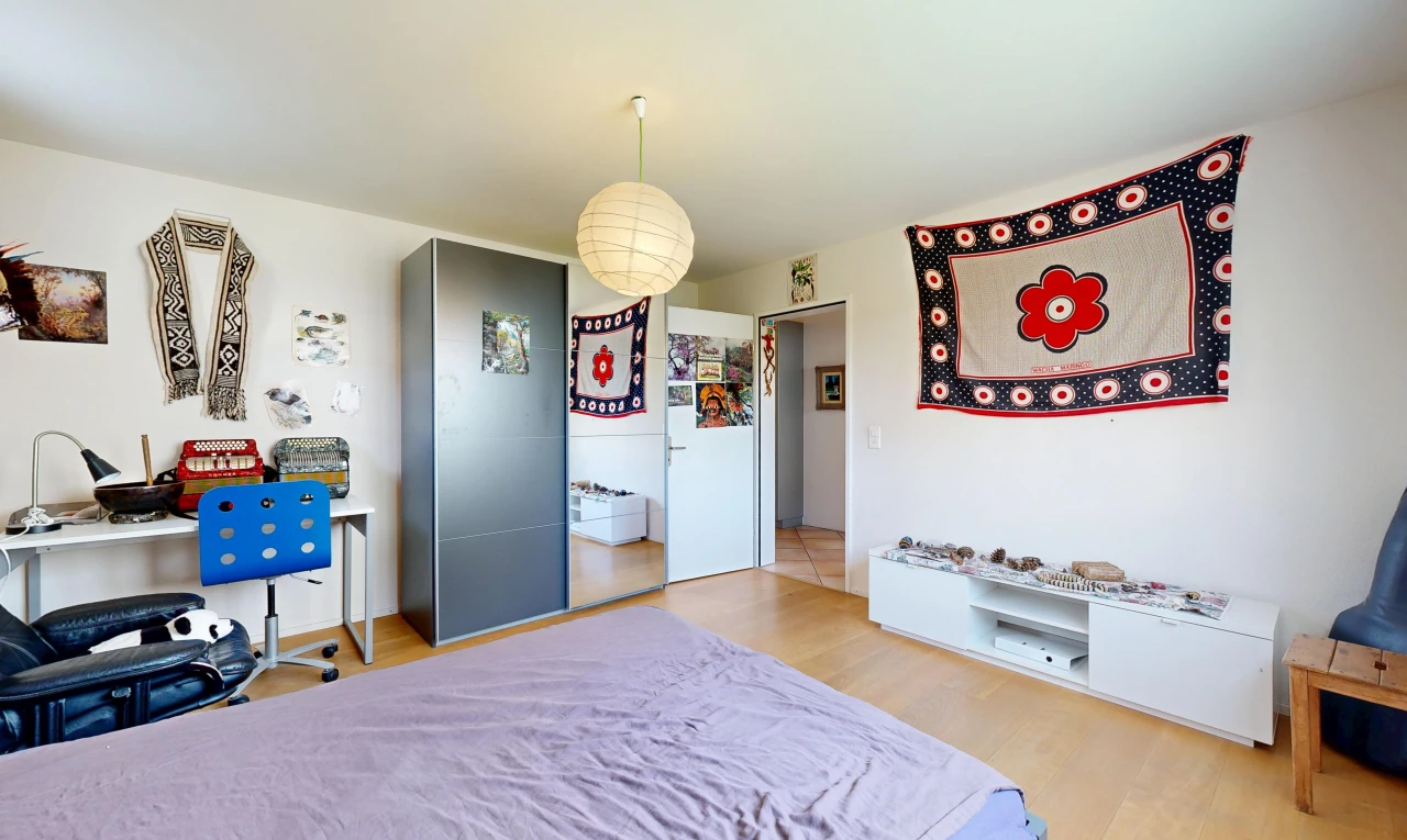 room with light wood-style floors, decorative light fixtures, and an office area