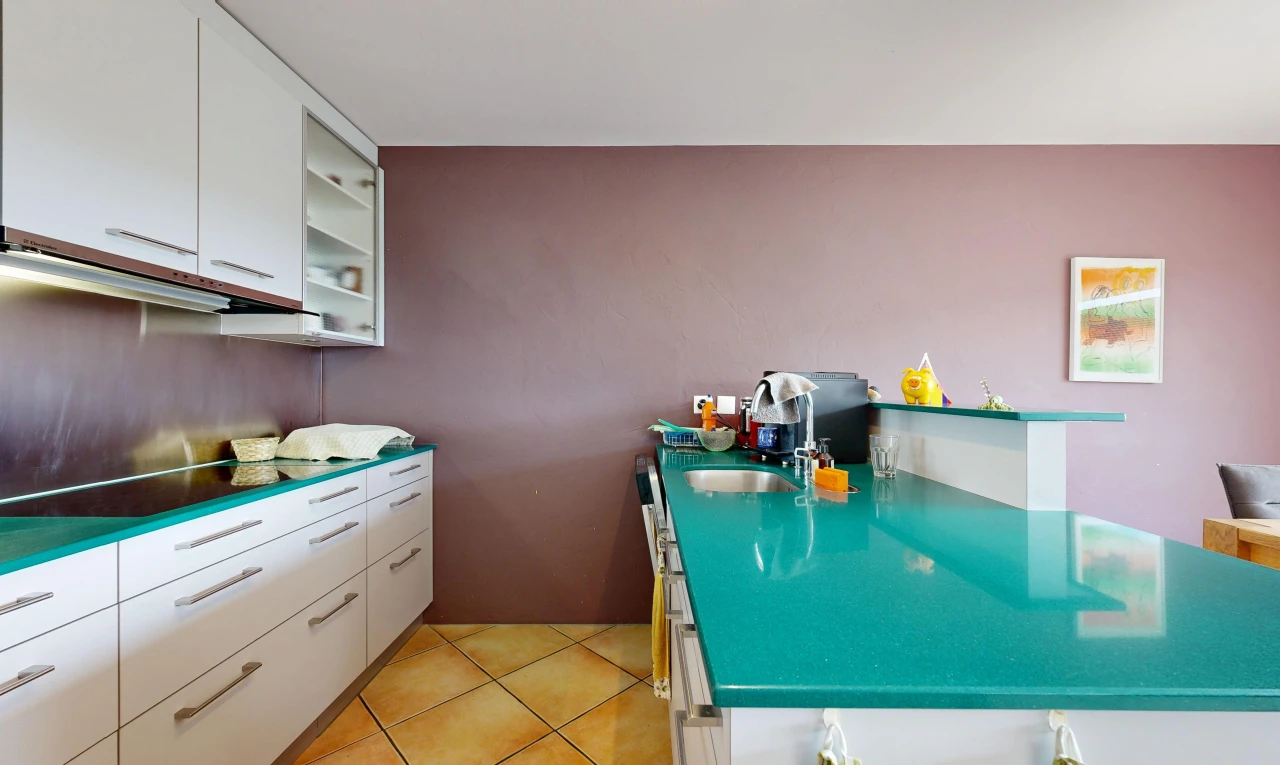 kitchen with white cabinetry, dark countertops, light tile patterned floors, and a peninsula