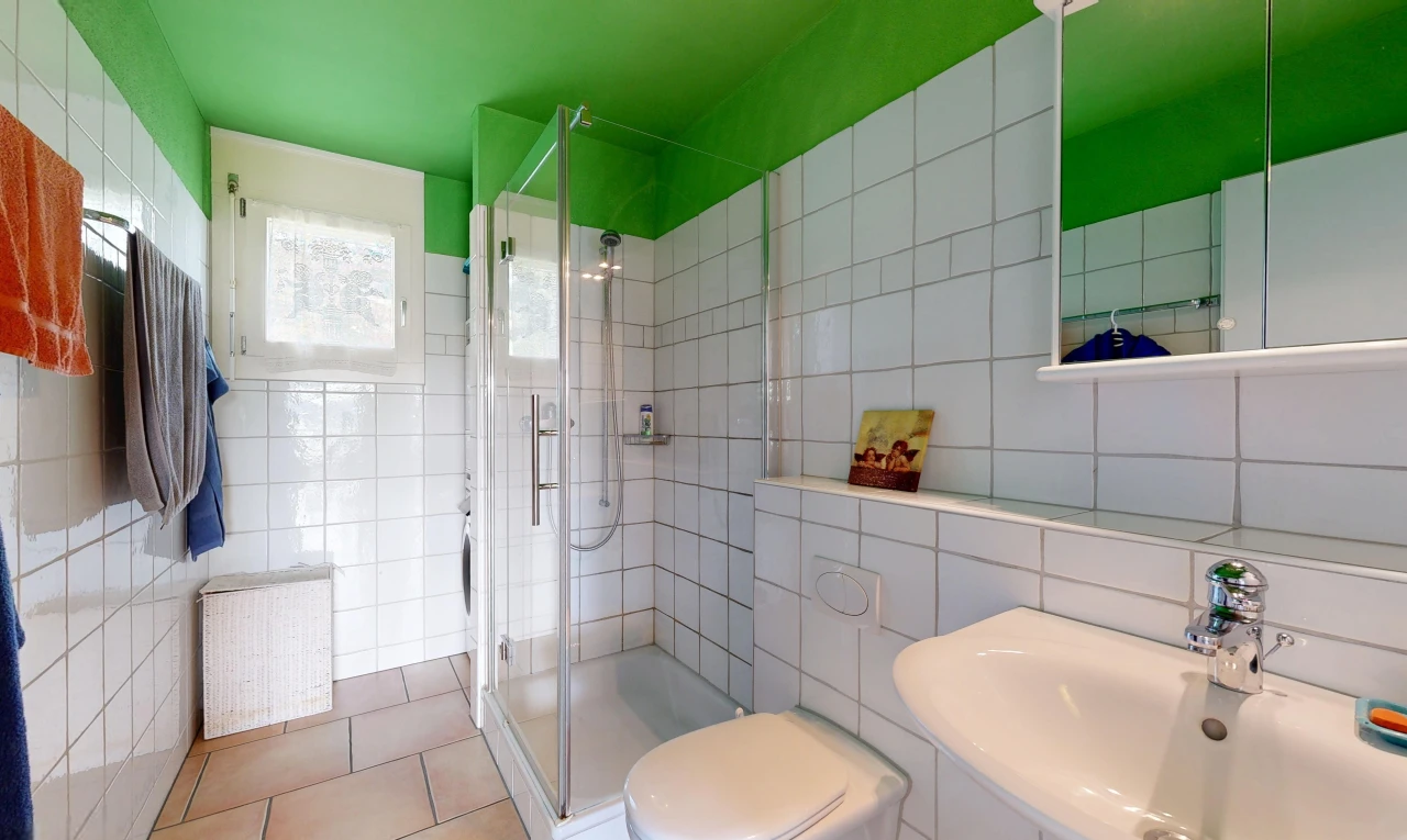 bathroom featuring a stall shower, tile walls, and light tile patterned flooring
