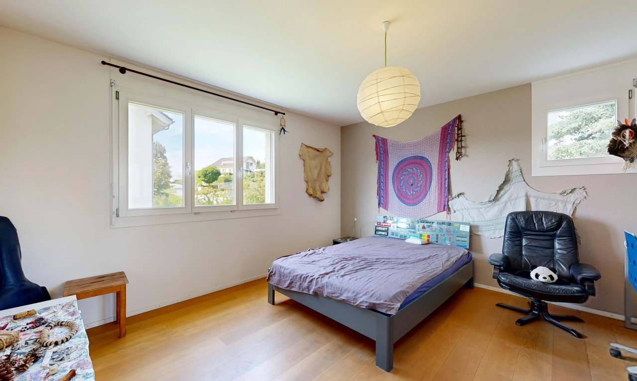 room / bedroom featuring pendant lighting and light wood-style flooring