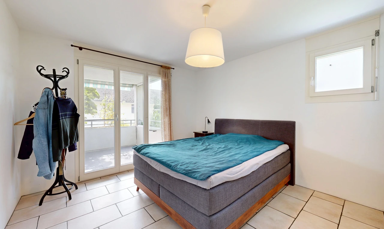 room with access to exterior, decorative light fixtures, and light tile patterned floors