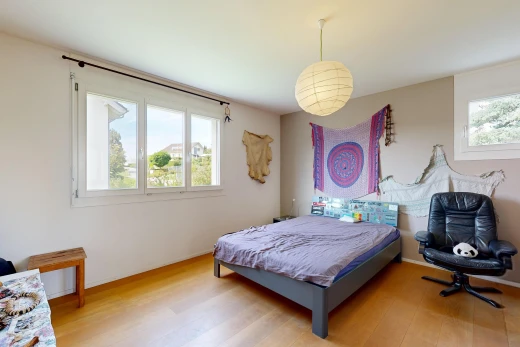 room / bedroom featuring pendant lighting and light wood-style flooring
