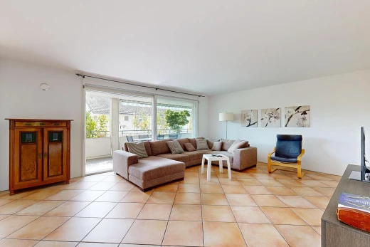 living area featuring light tile patterned flooring and access to outside