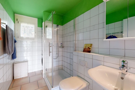 bathroom featuring a stall shower, tile walls, and light tile patterned flooring