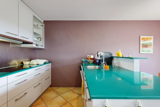 kitchen with white cabinetry, dark countertops, light tile patterned floors, and a peninsula