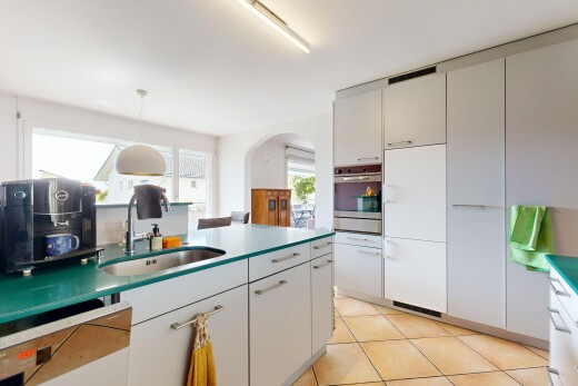kitchen with arched walkways, pendant lighting, dishwashing machine, light tile patterned flooring, and oven