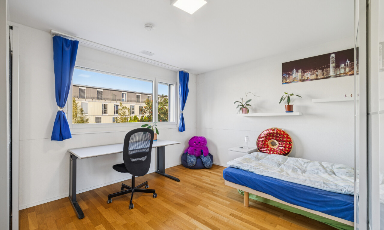 room / bedroom with a desk and light wood-style floors