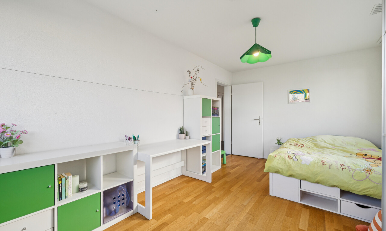 room with hanging light fixtures and light wood-style floors