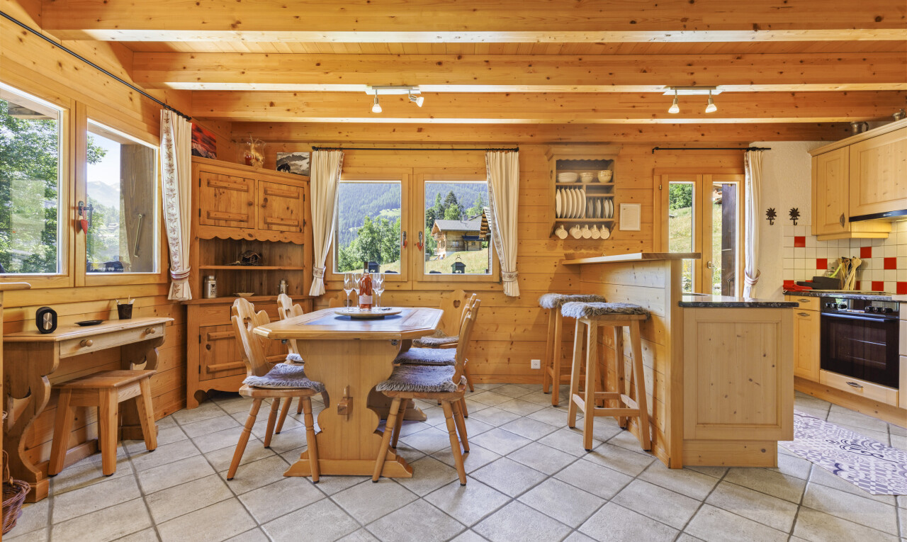 dining space featuring rail lighting, light tile patterned floors, and a wooden ceiling with exposed beams