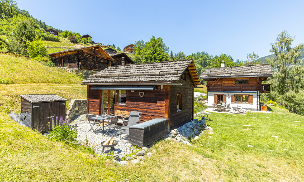 view of home with a patio area, an outbuilding, and a yard