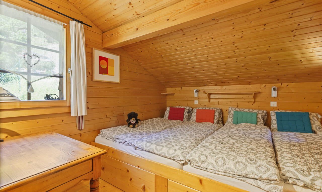 room / bedroom featuring wood walls and a vaulted wood ceiling
