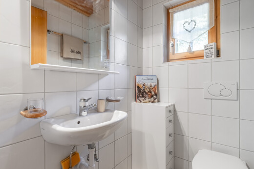 salle de bains avec miroir, mur en carrelage, tile wall, évier, et inside property