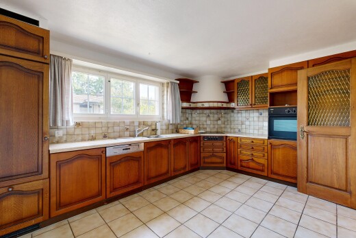 kitchen with tasteful backsplash, light countertops, open shelves, wood finish cabinetry, and black appliances
