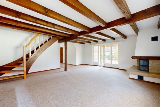 leerer raum mit balkendecke, beamed ceiling, treppen, kamin, und gipskartonwand