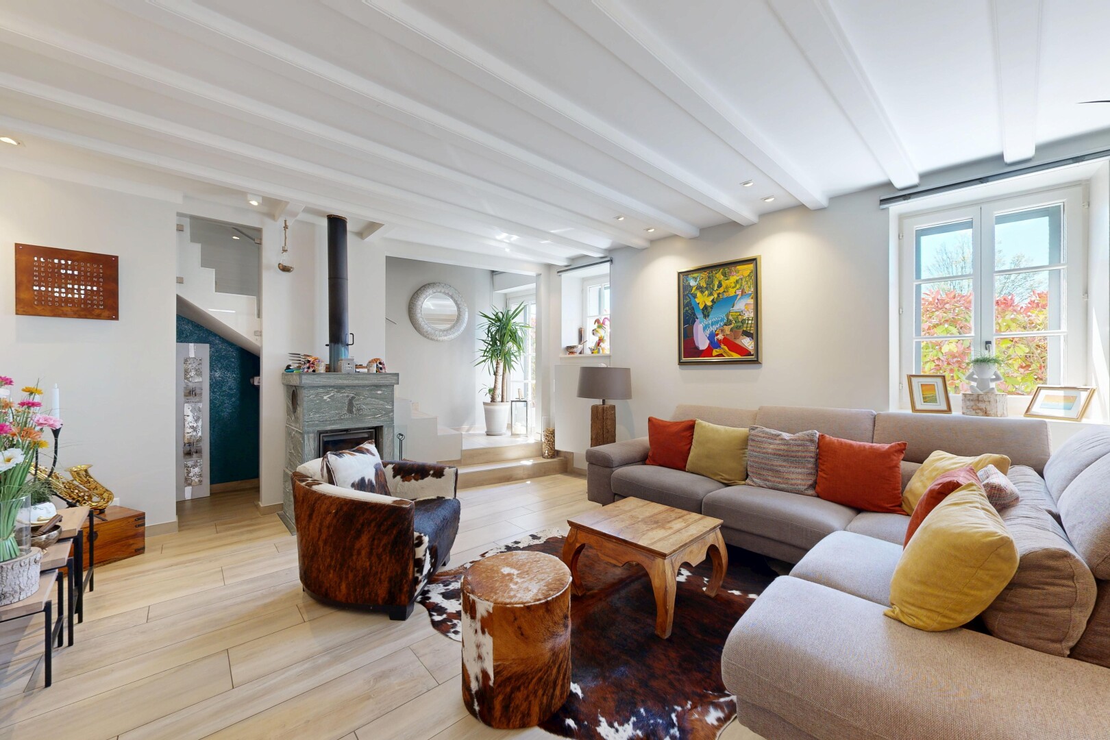 living area featuring beamed ceiling, wood finished floors, a fireplace, and recessed lighting