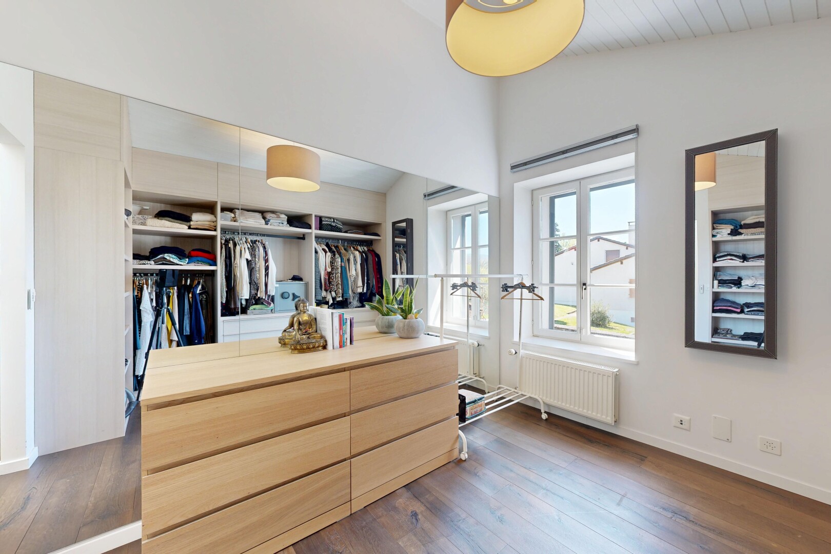 walk in closet with dark wood finished floors, radiator heating unit, and lofted ceiling
