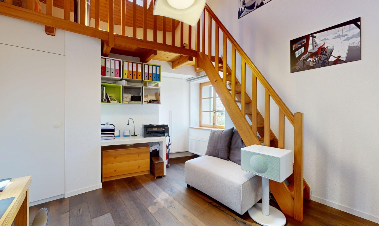 living area with stairs and dark wood-style floors
