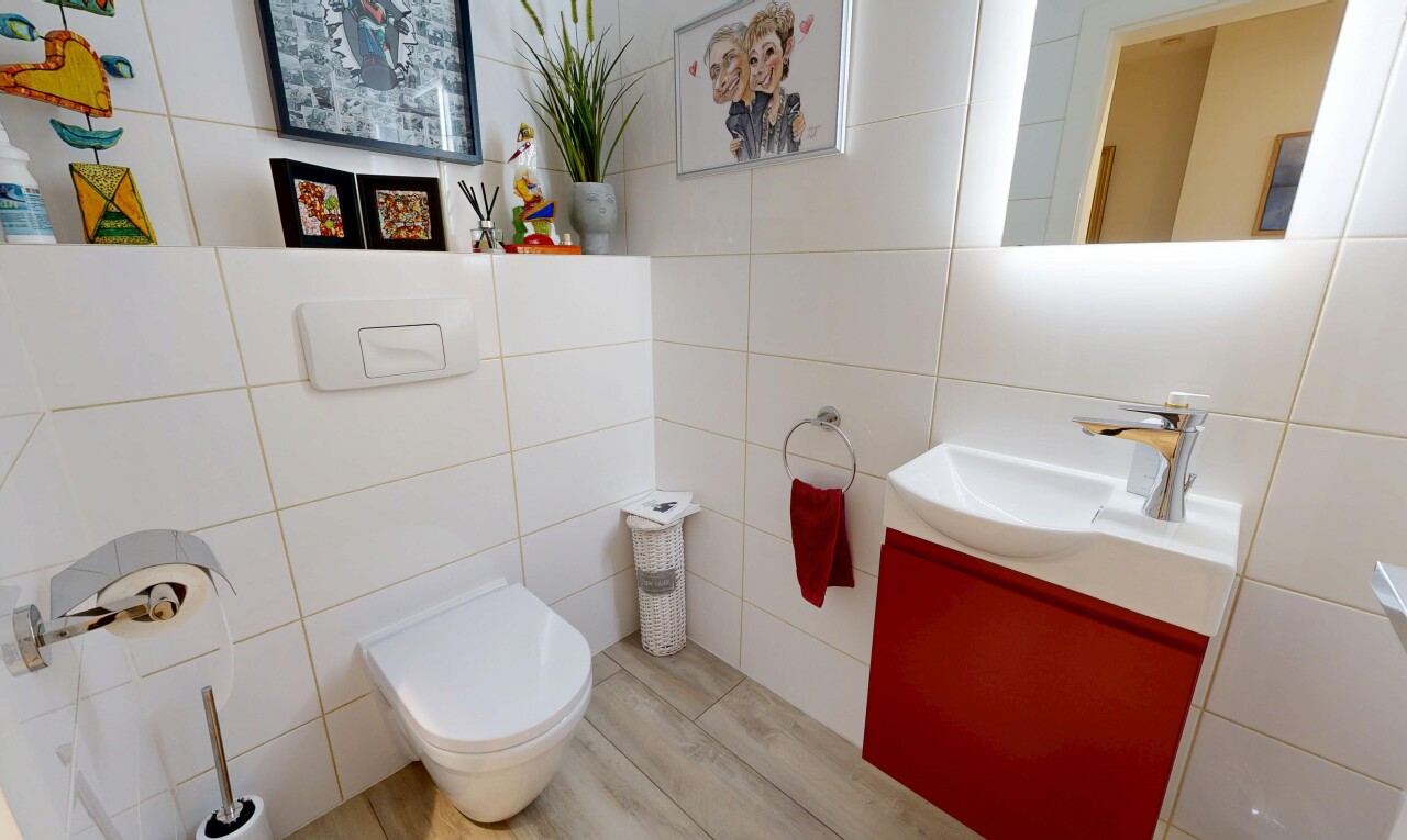 half bathroom featuring vanity and tile walls
