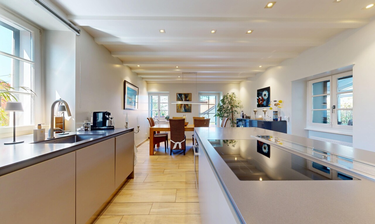 kitchen with light wood-style floors, black electric stovetop, and decorative light fixtures