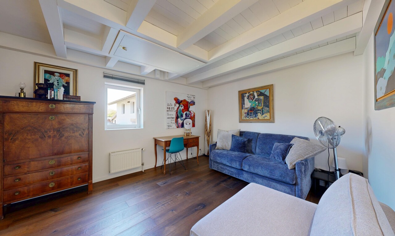 living room with beam ceiling, dark wood-style floors, and radiator