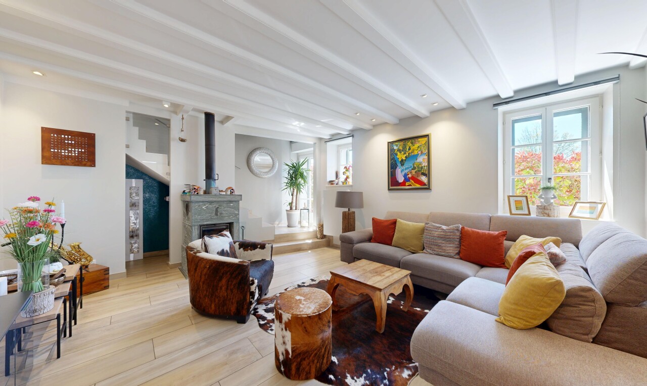 living area featuring beamed ceiling, wood finished floors, a fireplace, and recessed lighting