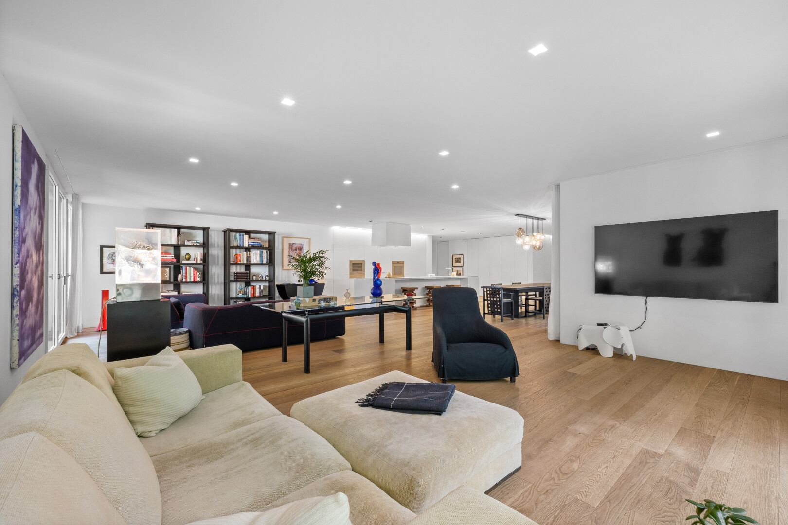 living room featuring wood finished floors and suspended lighting