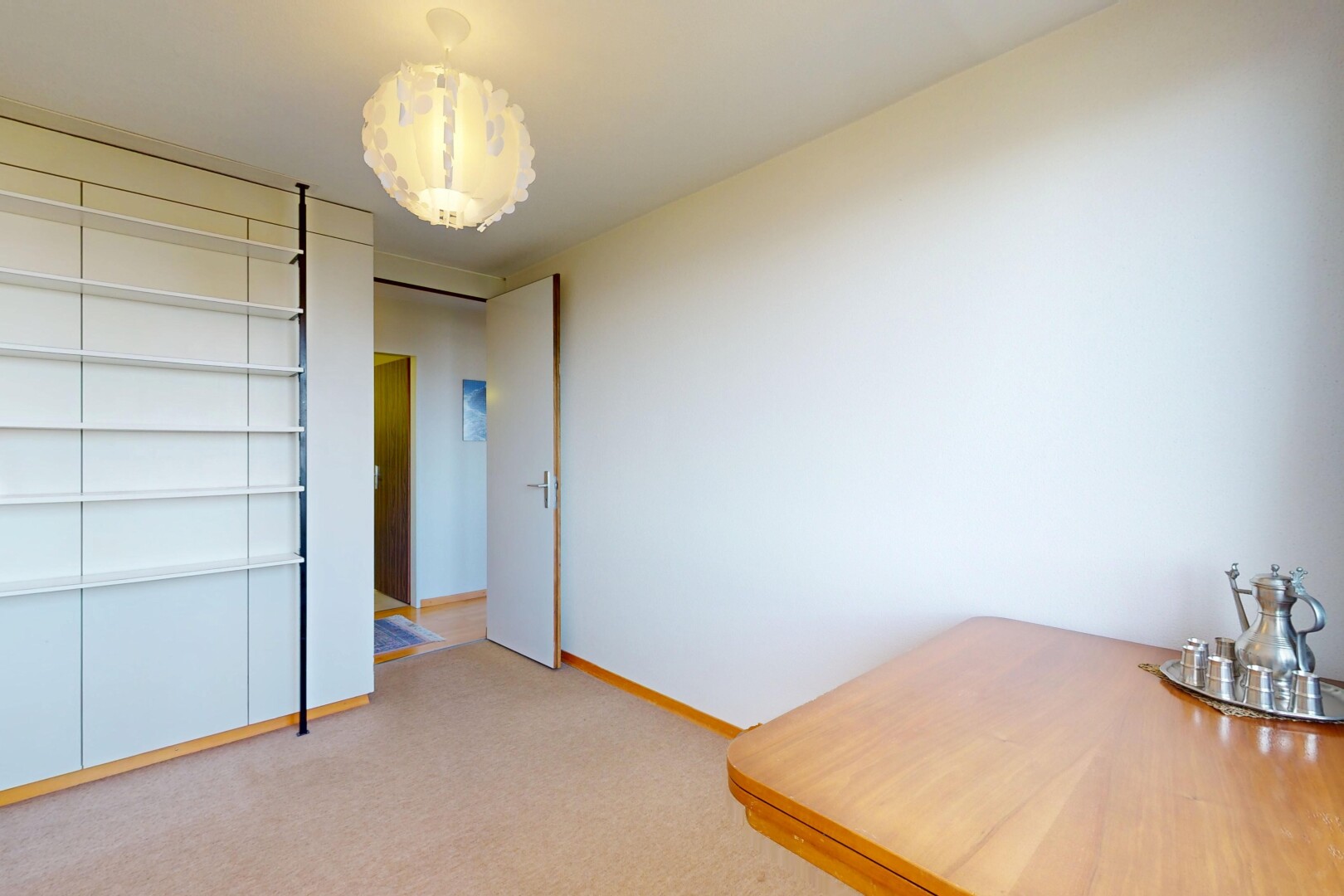 spare room with light colored carpet and baseboards