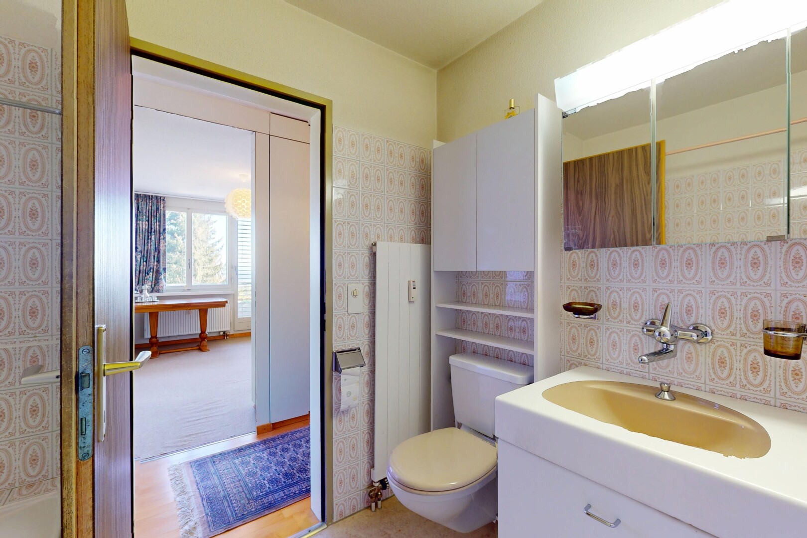 bathroom with radiator heating unit, vanity, and toilet