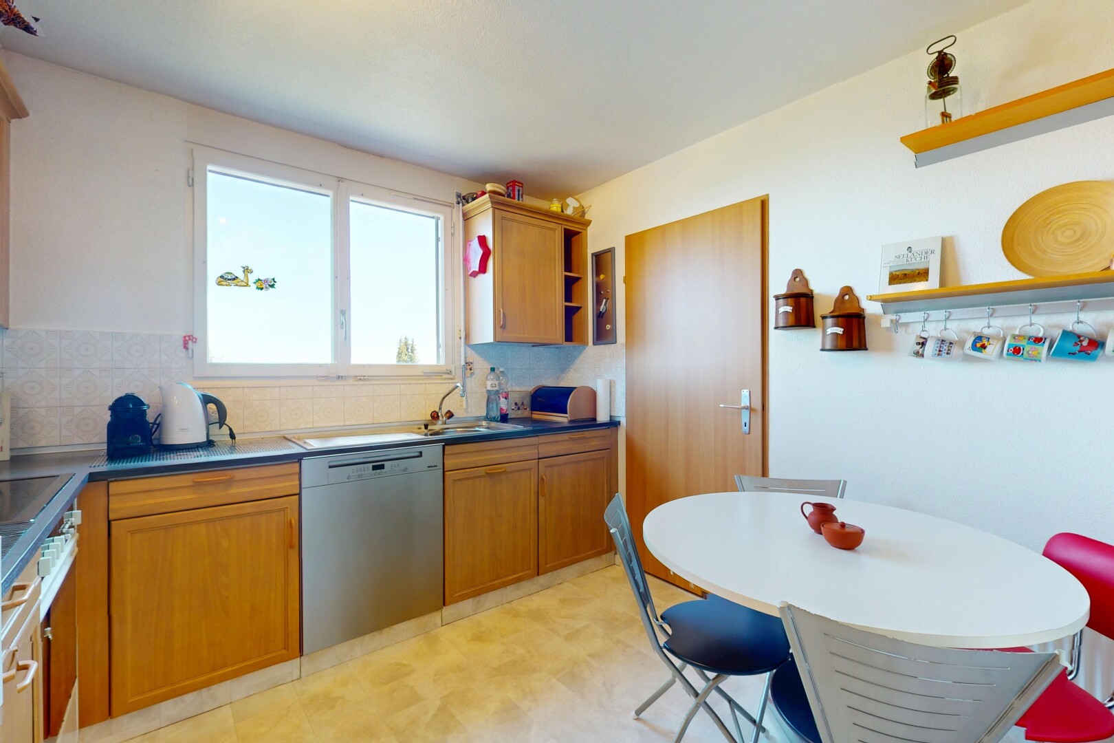kitchen with stainless steel dishwasher, light floors, brown cabinetry, open shelves, and decorative backsplash
