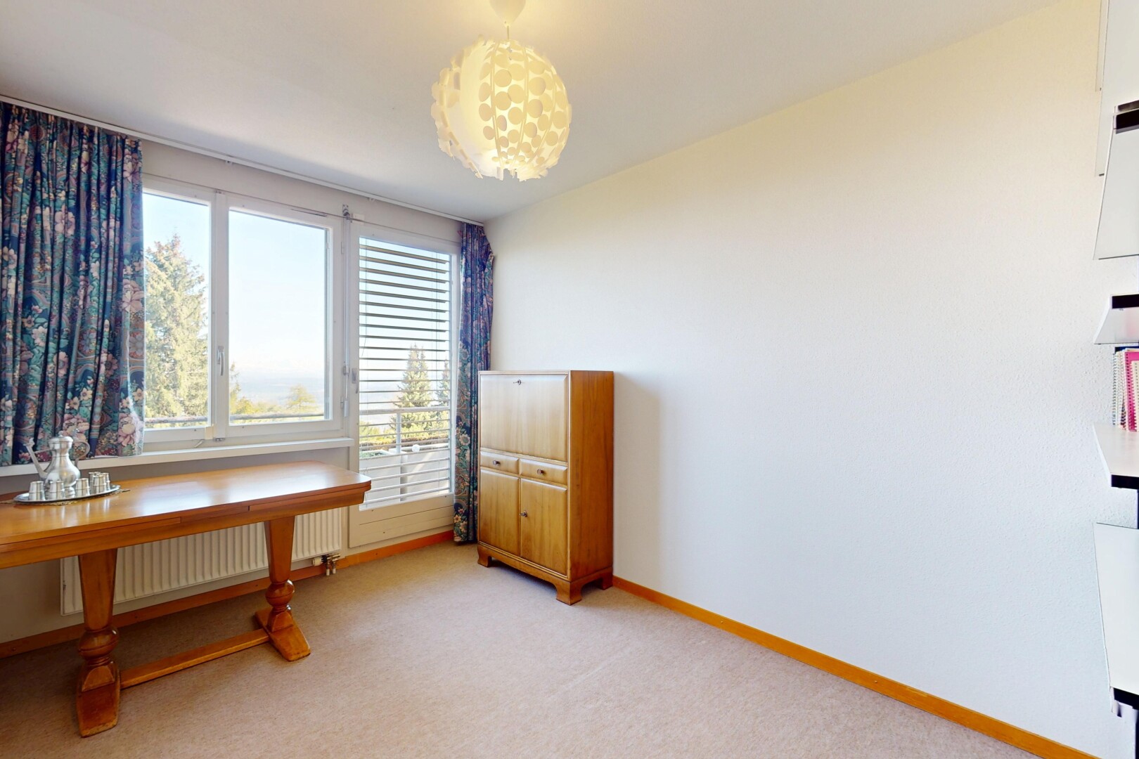 office area featuring radiator heating unit, light colored carpet, and baseboards