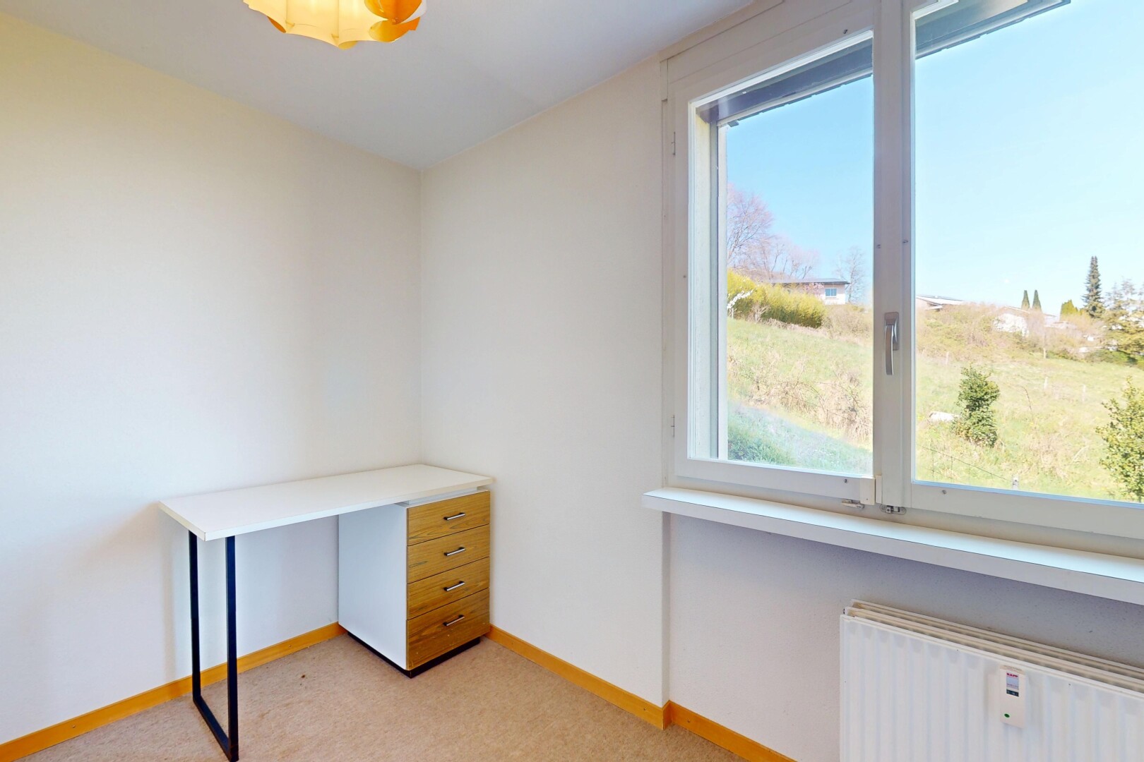 interior space with light carpet, radiator, and baseboards
