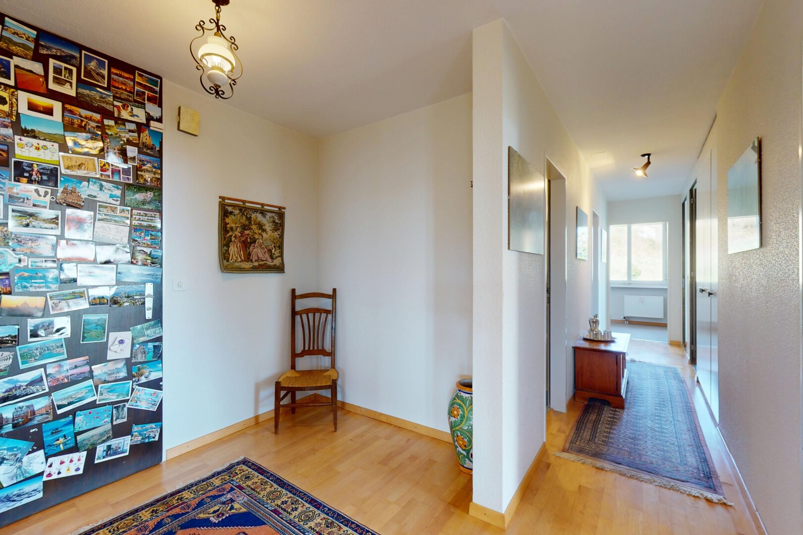 hallway featuring wood finished floors and baseboards