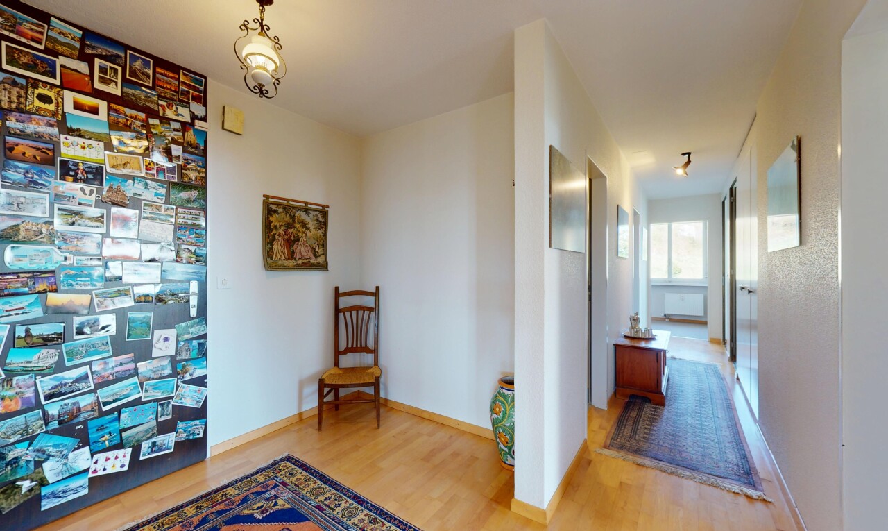 hallway featuring wood finished floors and baseboards