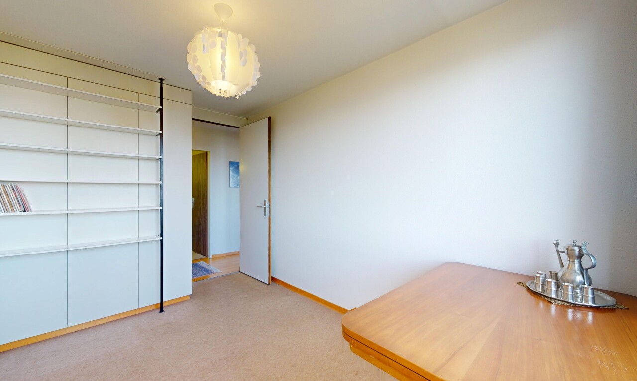 spare room with light colored carpet and baseboards