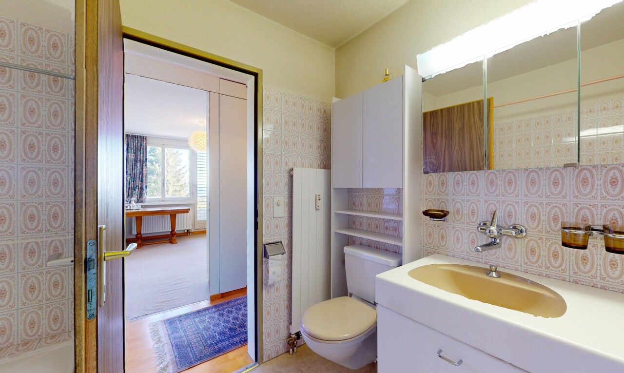 bathroom with radiator heating unit, vanity, and toilet