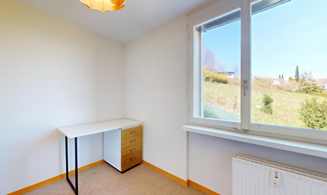 interior space with light carpet, radiator, and baseboards