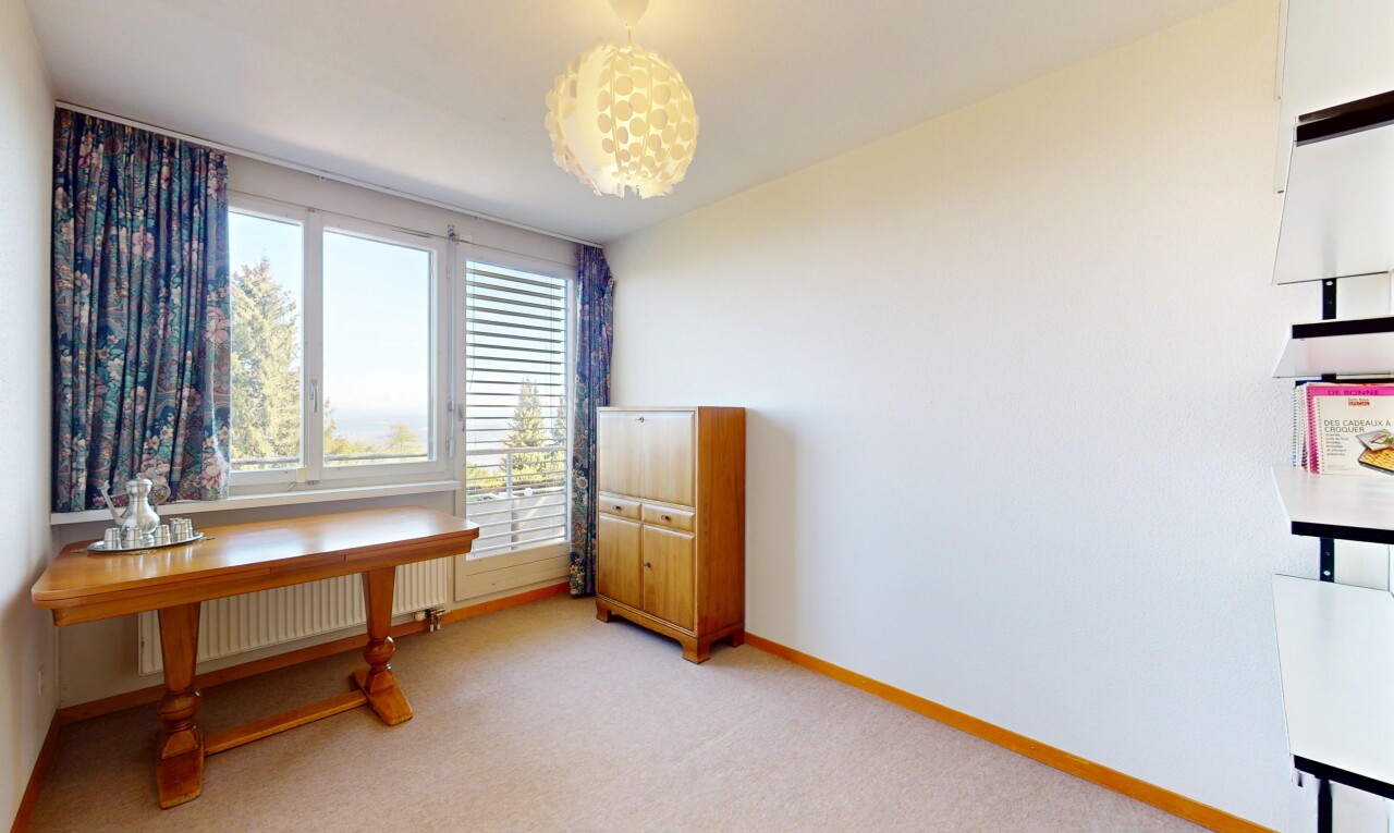 office area featuring radiator heating unit, light colored carpet, and baseboards