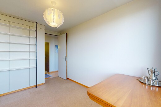 spare room with light colored carpet and baseboards