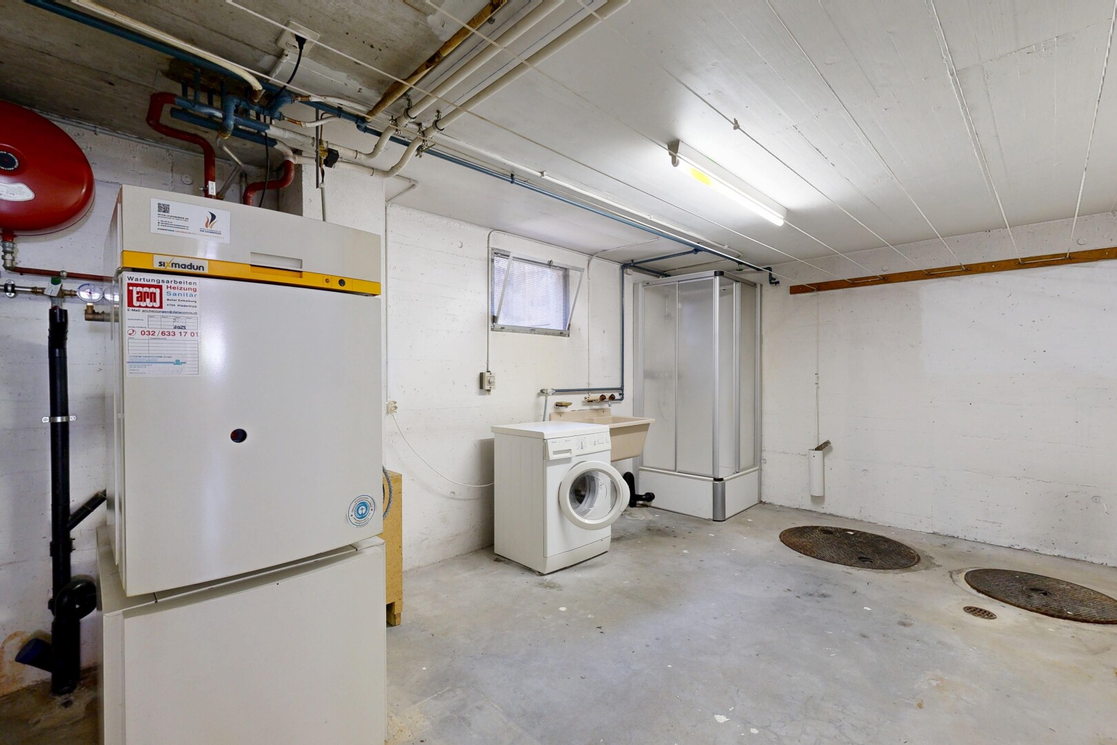 laundry area with concrete floors and washer / dryer