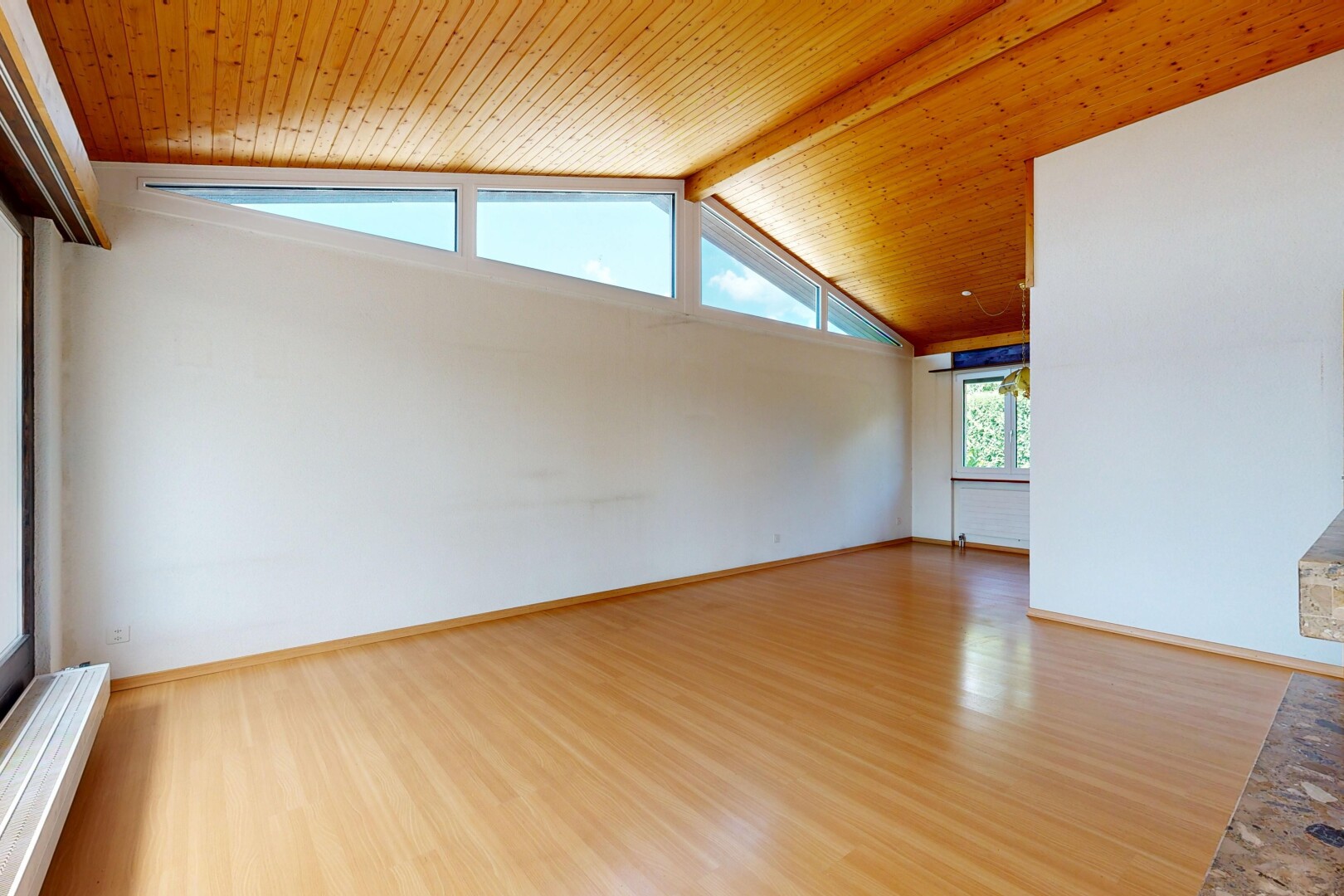 empty room with a wood ceiling with exposed beams and wood finished floors