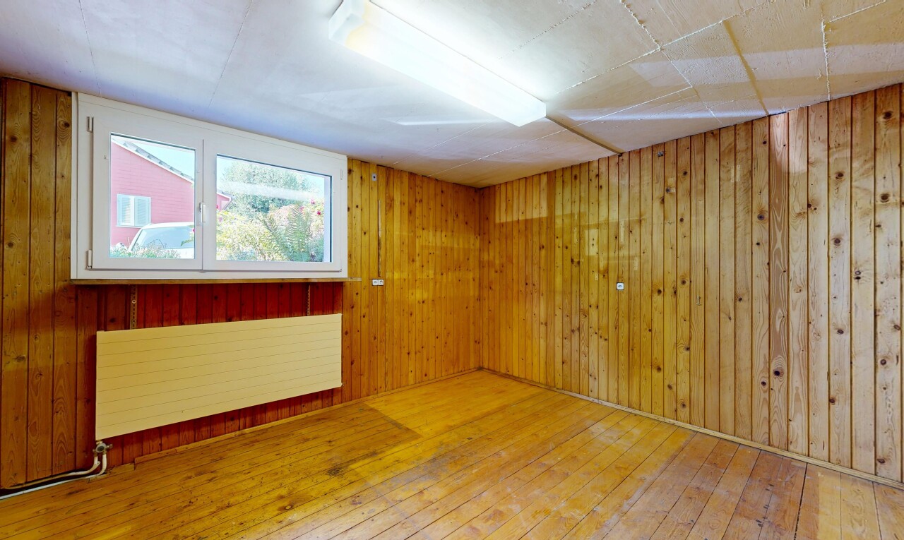 spare room featuring hardwood / wood-style flooring and wooden walls
