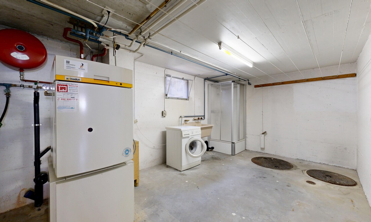 laundry area with concrete floors and washer / dryer