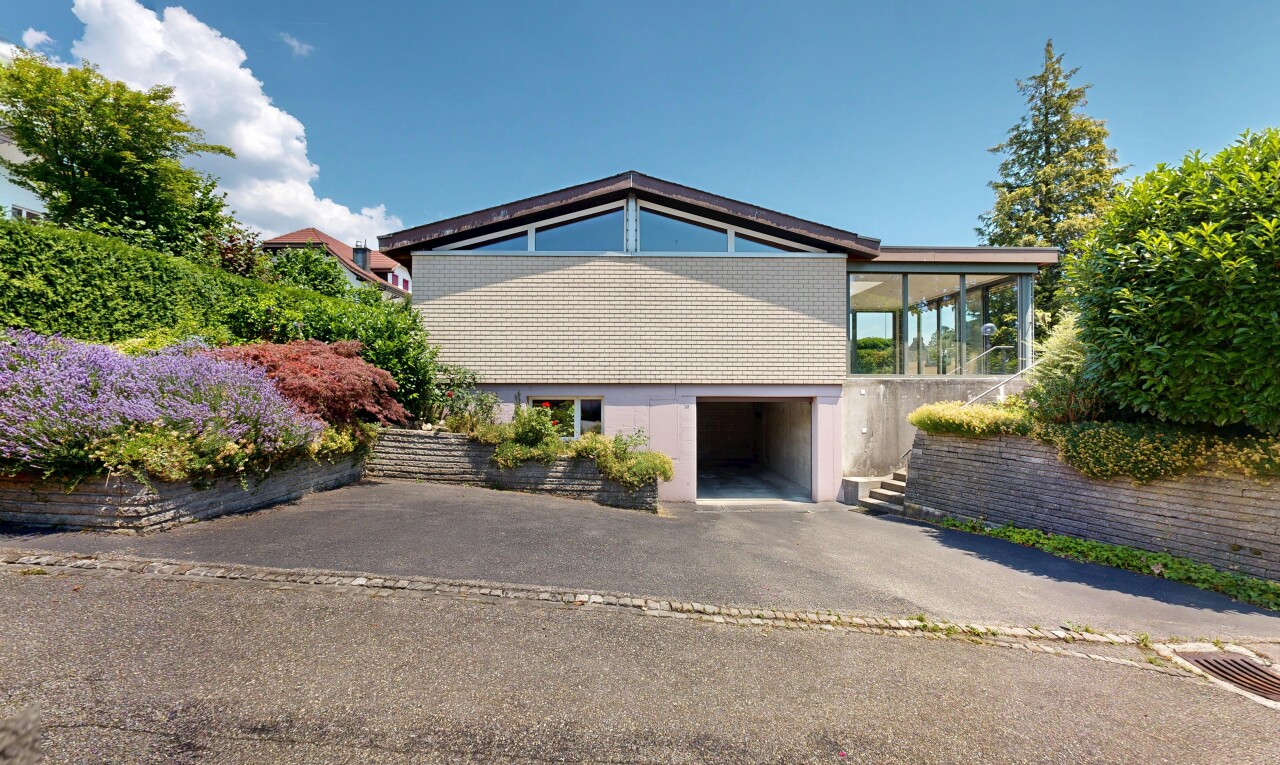view of home featuring a garage and driveway