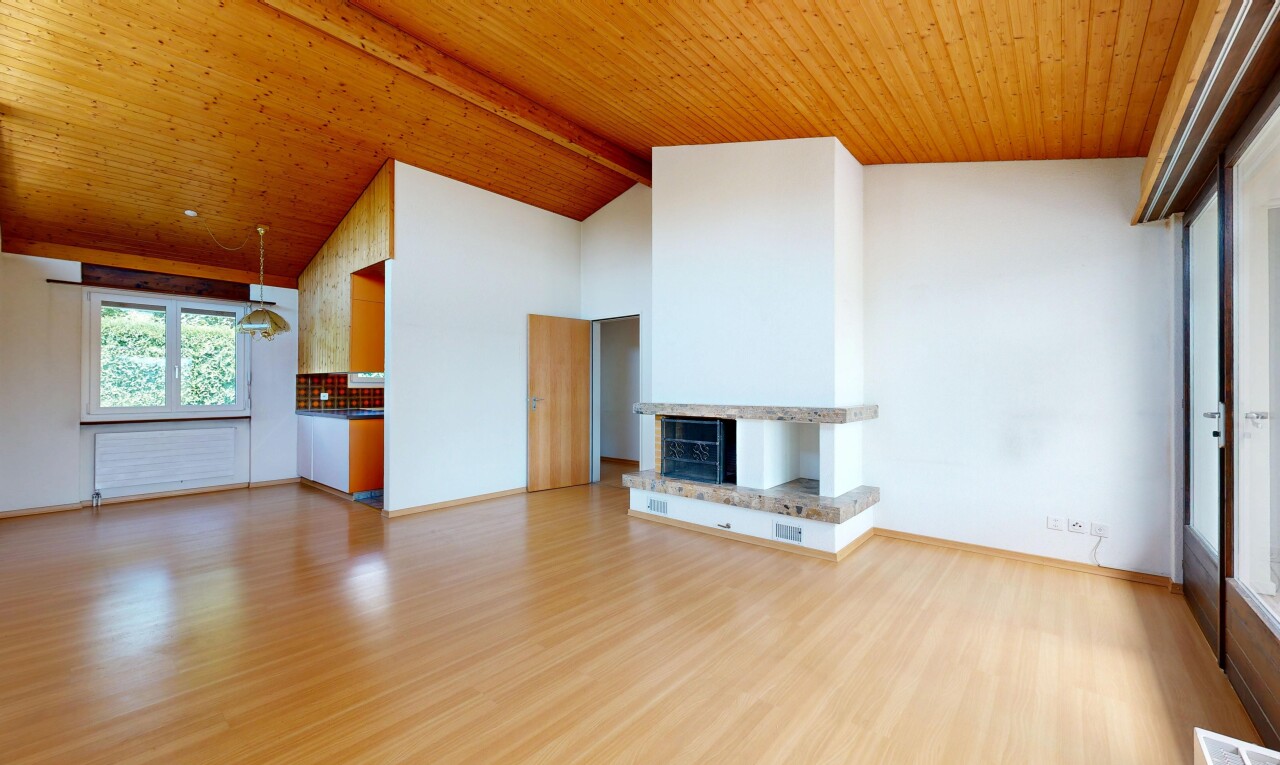 unfurnished living room featuring light wood finished floors, a high wood beamed ceiling, and a fireplace with raised hearth
