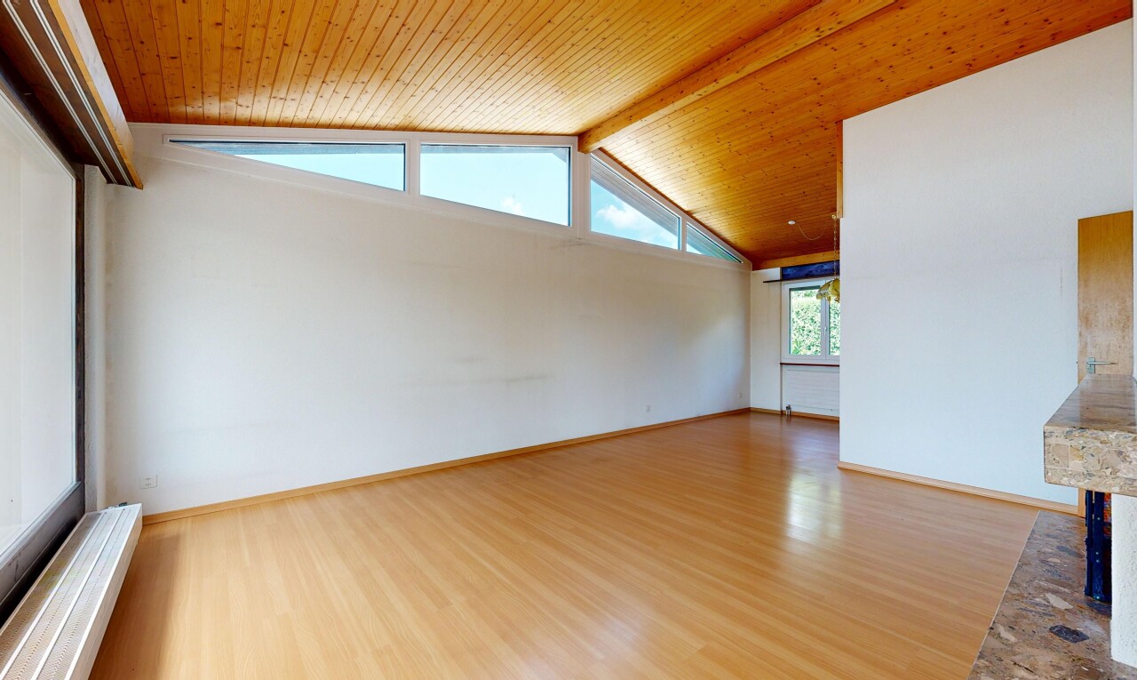 empty room with a wood ceiling with exposed beams and wood finished floors