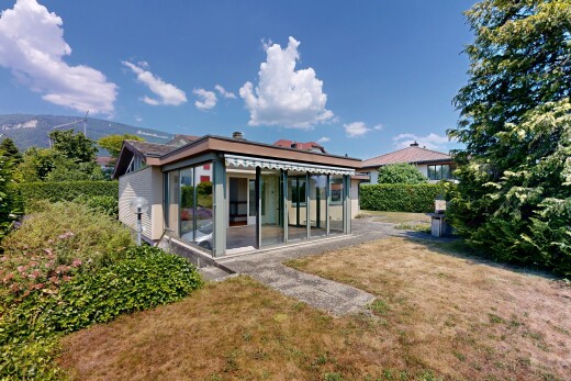 view of home featuring a yard and a sunroom