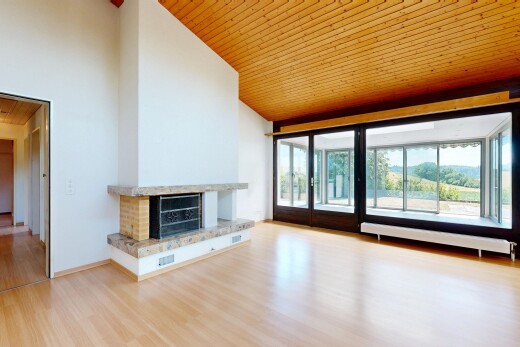 unfurnished room featuring a vaulted wooden ceiling, a fireplace with raised hearth, and light wood-style floors