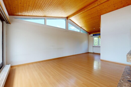 empty room with a wood ceiling with exposed beams and wood finished floors